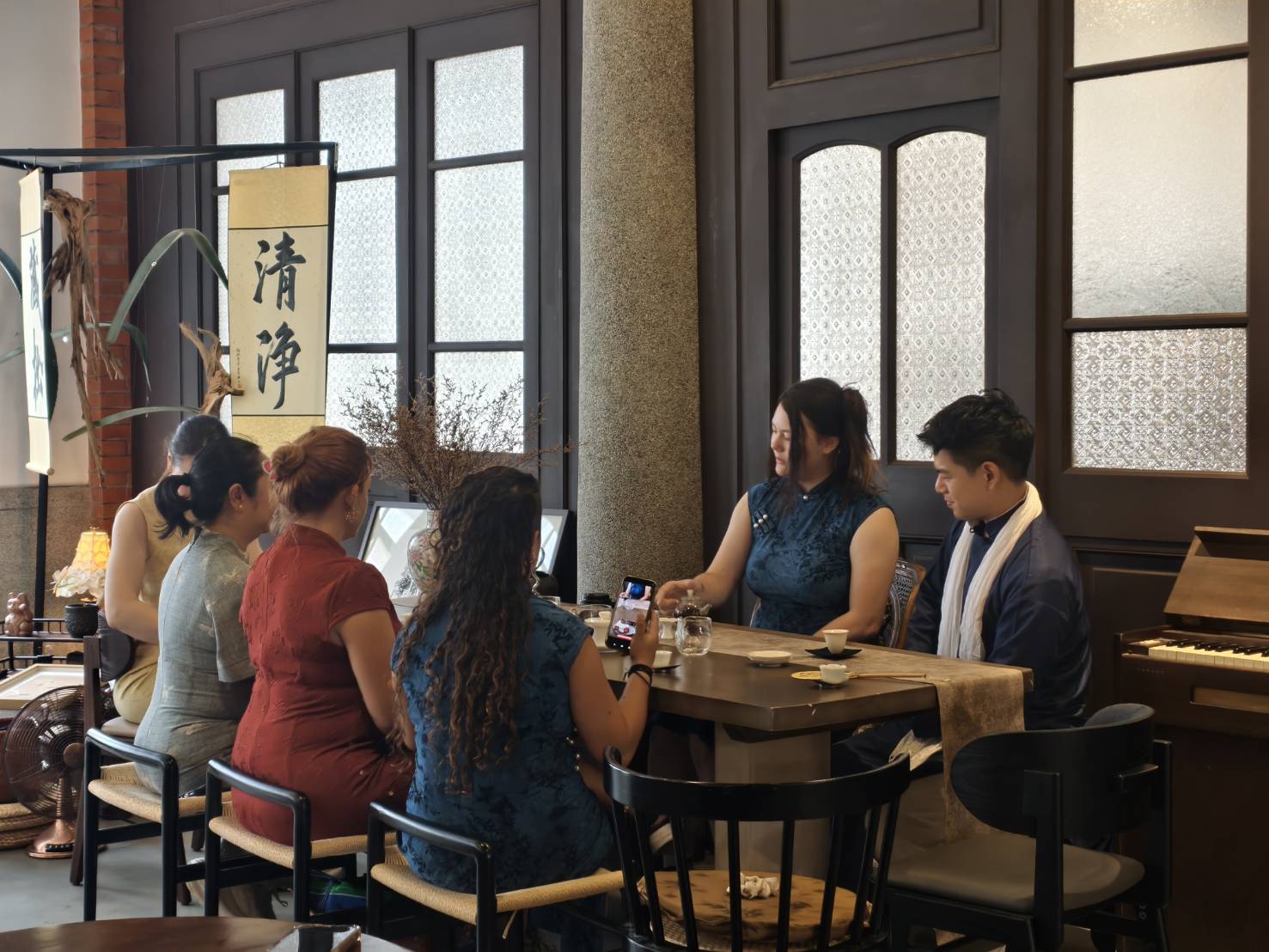 Guests in qipao around the tea table inside a 1934 Dadaocheng tea house